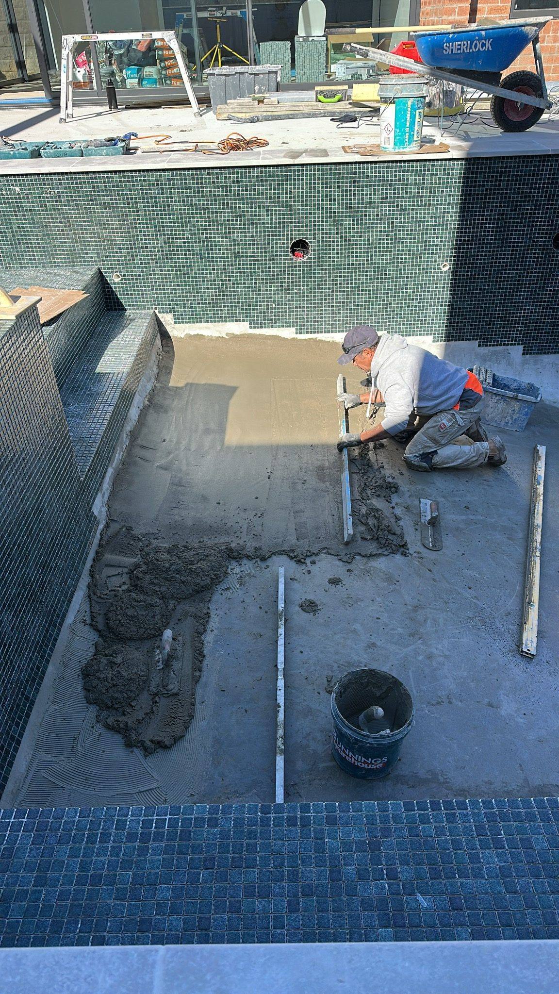 Leyton, our tiling specialist, tiling a full pool interior